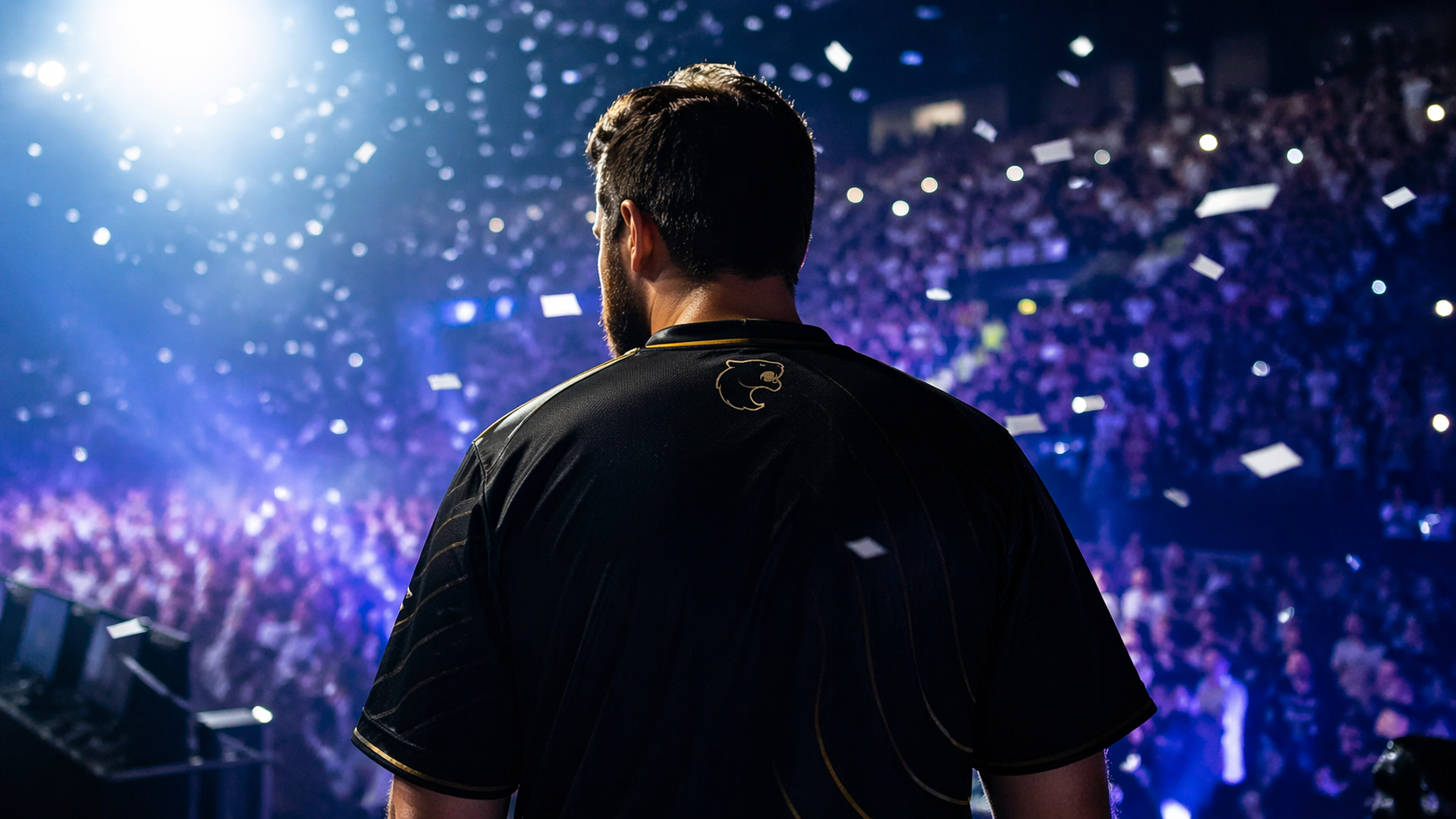 Jugador en un escenario de e-sports frente a una multitud durante un momento emotivo